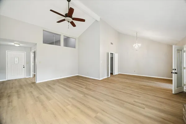 a view of empty room with wooden floor