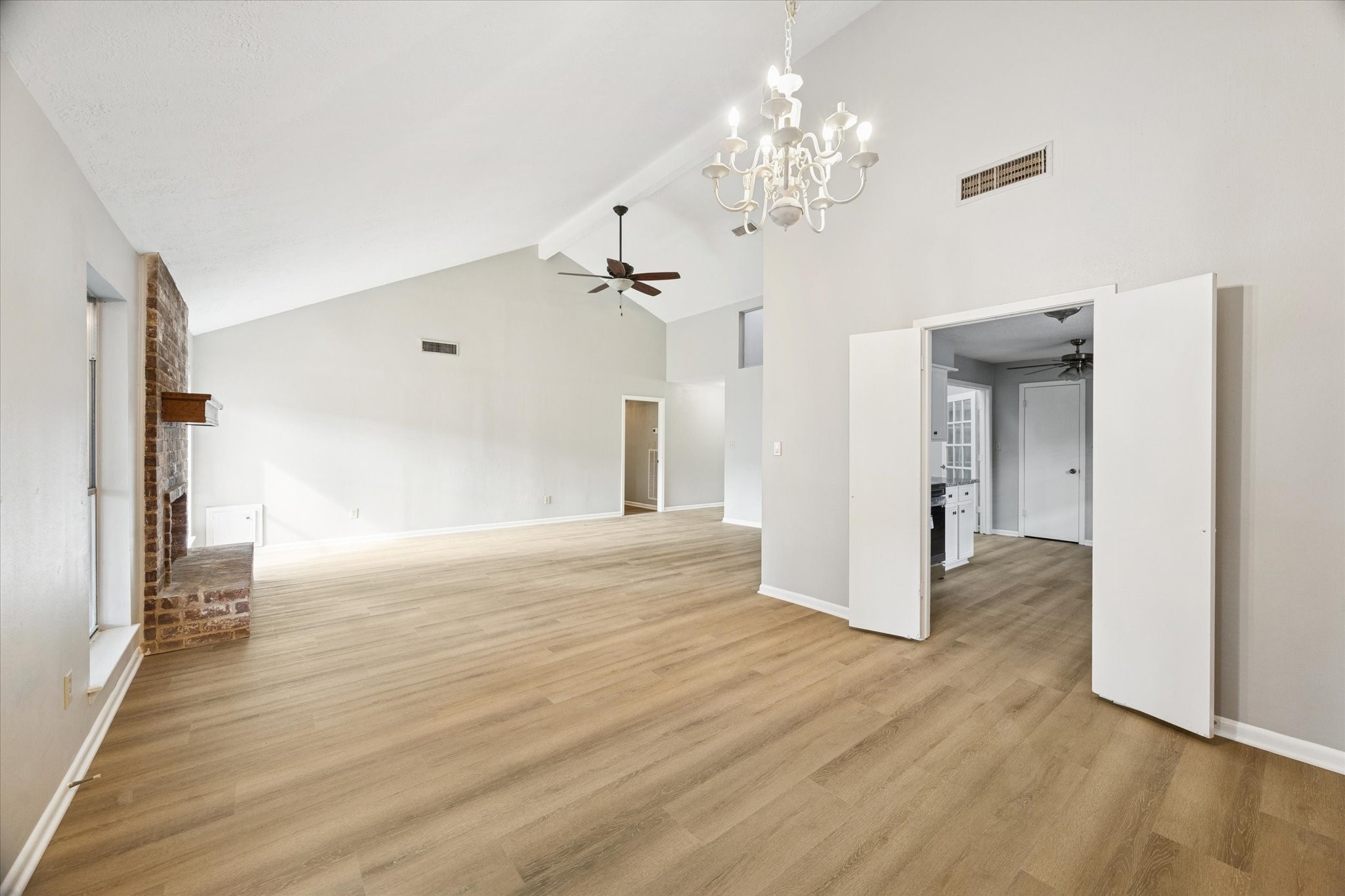 25903 Long Hill Lane Spring, TX 77373 - Photo 5 of 20 a view of a hallway with wooden floor and chandelier