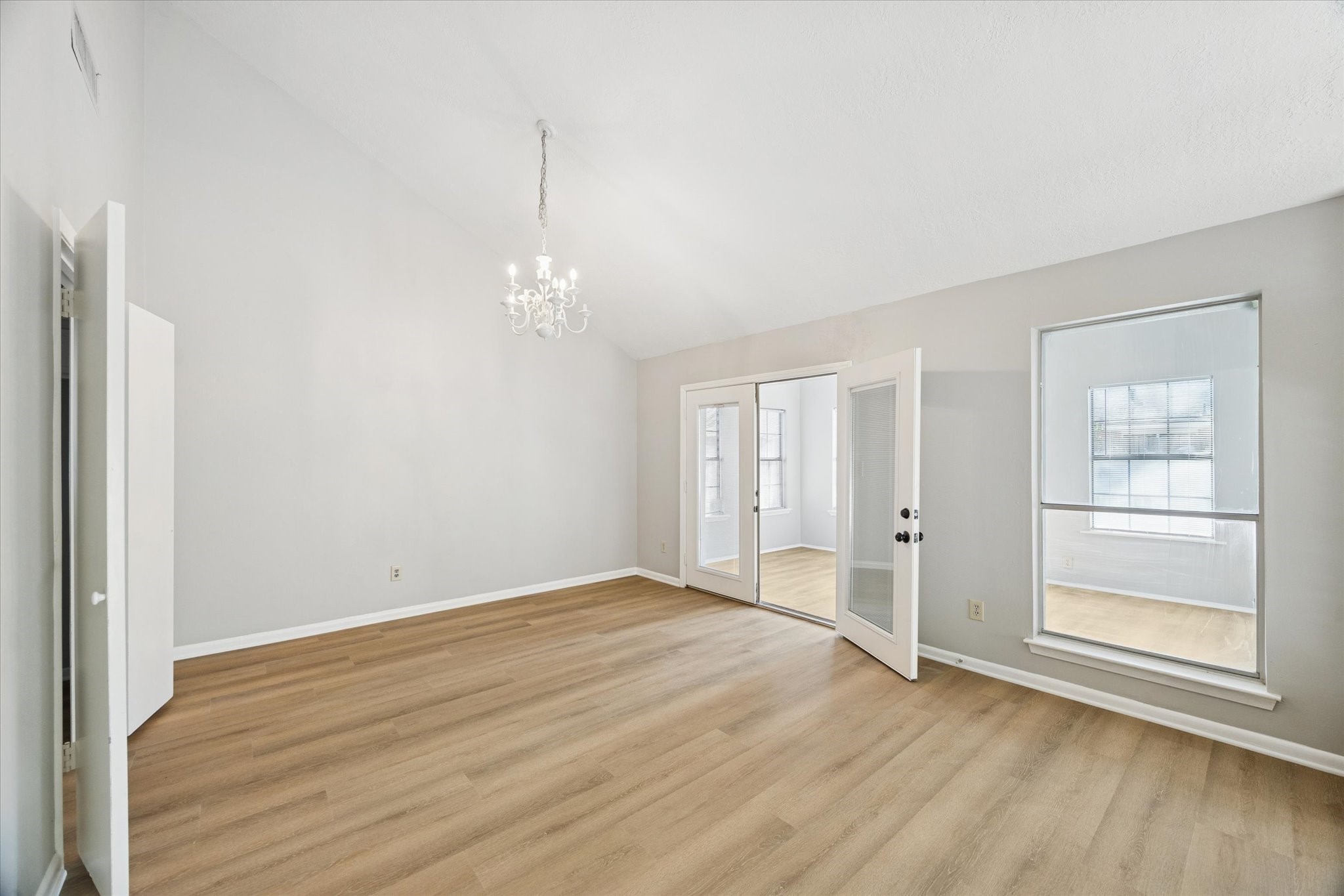 25903 Long Hill Lane Spring, TX 77373 - Photo 6 of 20 a view of an empty room with wooden floor and a window