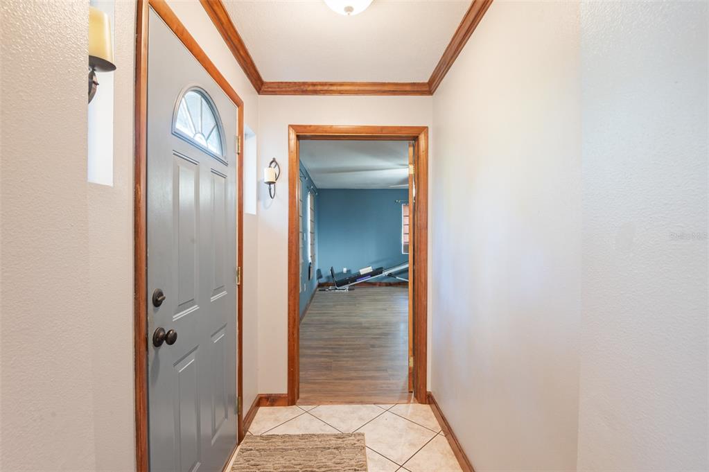 10620 Fawn Drive New Port Richey, FL 34654 - Photo 16 of 49 a view of a hallway with wooden floor and a bathroom
