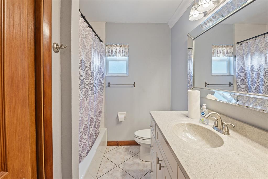 10620 Fawn Drive New Port Richey, FL 34654 - Photo 21 of 49 a bathroom with a granite countertop sink toilet and shower