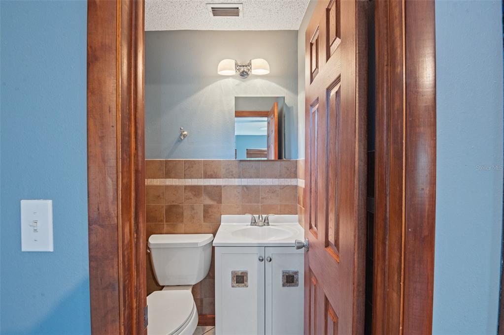 10620 Fawn Drive New Port Richey, FL 34654 - Photo 27 of 49 a bathroom with a sink mirror and toilet