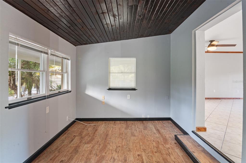 10620 Fawn Drive New Port Richey, FL 34654 - Photo 32 of 49 a view of an empty room with wooden floor and a window