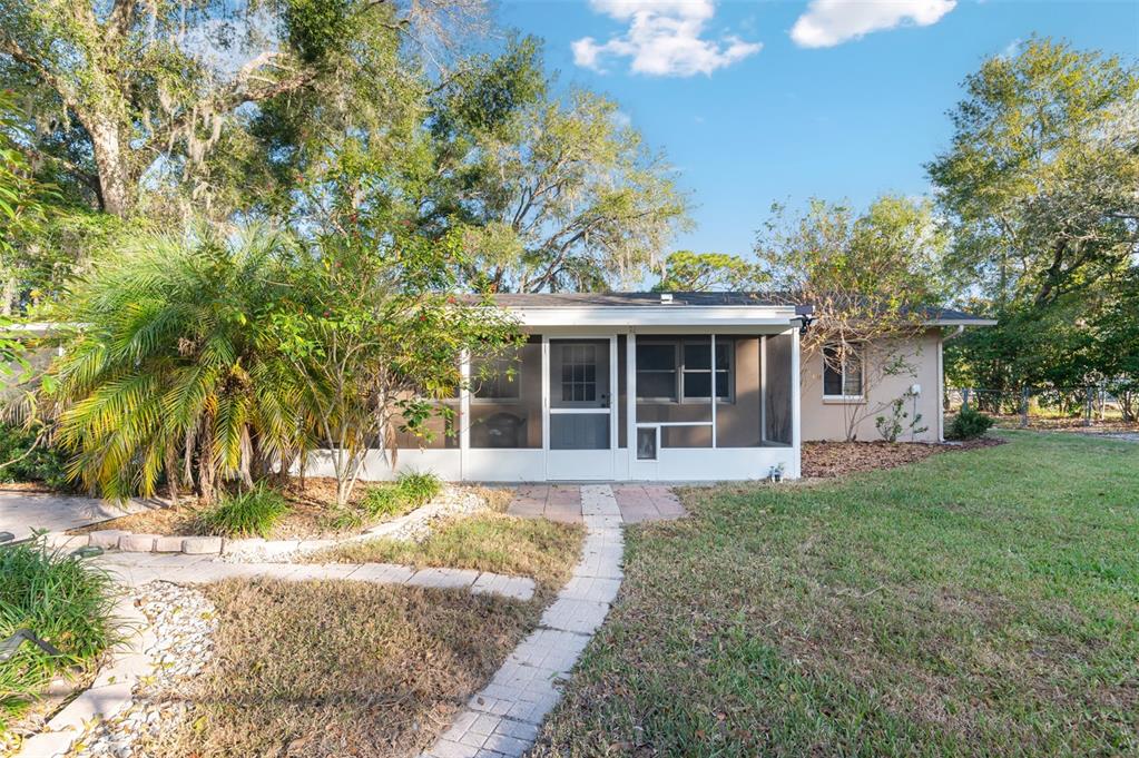 10620 Fawn Drive New Port Richey, FL 34654 - Photo 37 of 49 a front view of a house with a yard and potted plants