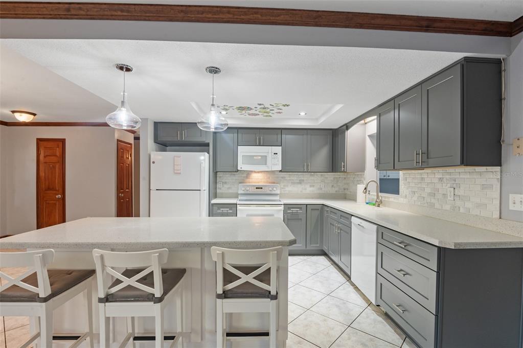 10620 Fawn Drive New Port Richey, FL 34654 - Photo 4 of 49 a kitchen with cabinets and chairs