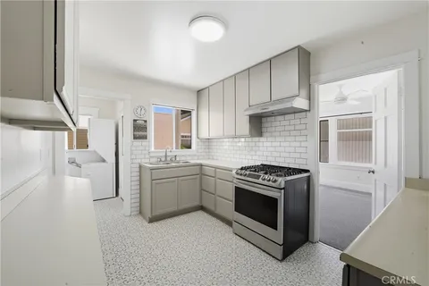 a kitchen with cabinets and appliances