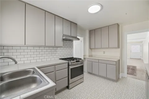 a kitchen that has a sink and a stove