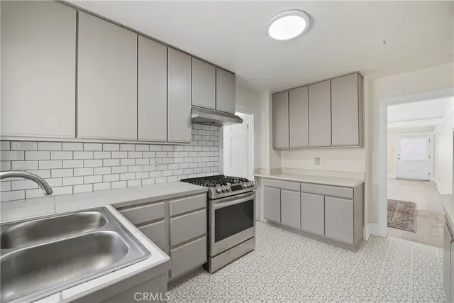 a kitchen that has a sink and a stove