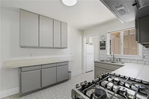 a kitchen with a sink stove and cabinets