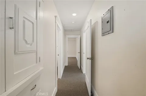 a view of a hallway with closet and wooden floor