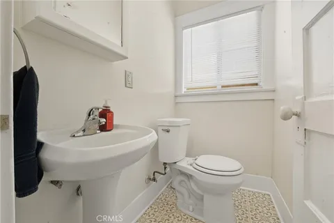 a bathroom with a sink toilet and a mirror