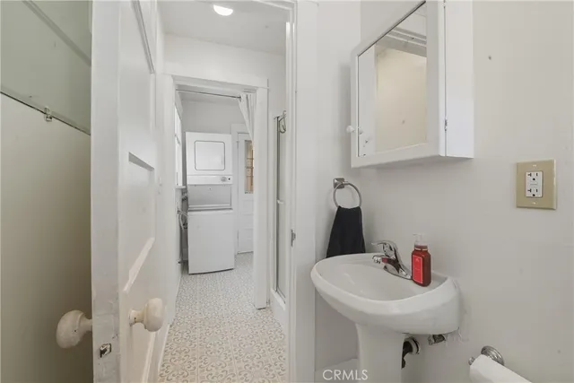 a bathroom with a sink toilet and a mirror