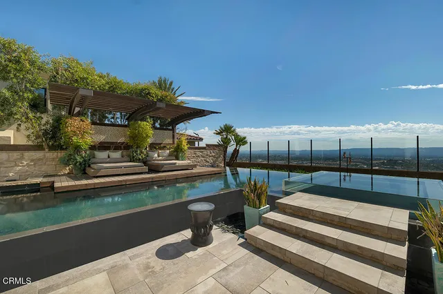 a spacious bathroom with a glass shower sink and mirror