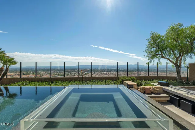 a living room with furniture a flat screen tv and a floor to ceiling window