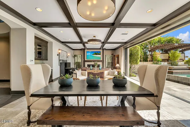 a large kitchen with stainless steel appliances a large counter top a stove and a sink