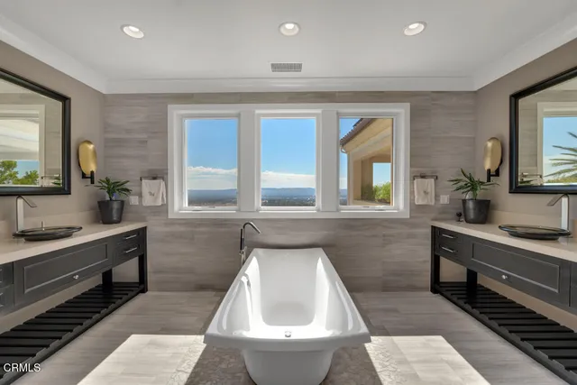 a view of a white house with a yard and plants