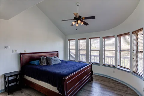 a bedroom with a bed and a window