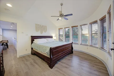 a bedroom with a large bed and a large window