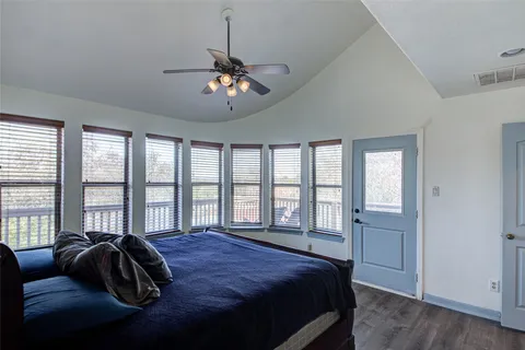 a bedroom with a bed and a large window