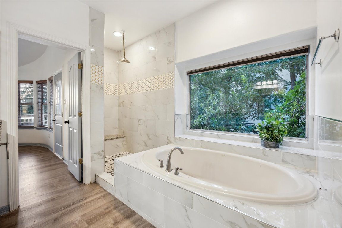 602 Jessie Street Austin, TX 78704 - Photo 17 of 32 a white bath tub sitting in a bathroom next to a window