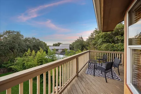 a balcony with wooden floor and outdoor space