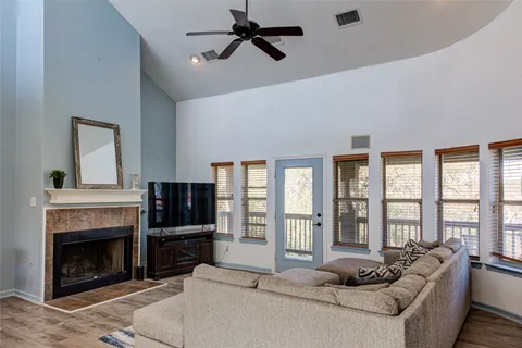a living room with furniture a flat screen tv and a fireplace