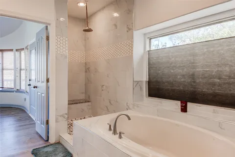 a bathroom with a bathtub and a shower