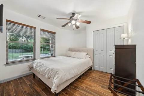 a bedroom with a bed and wooden floor