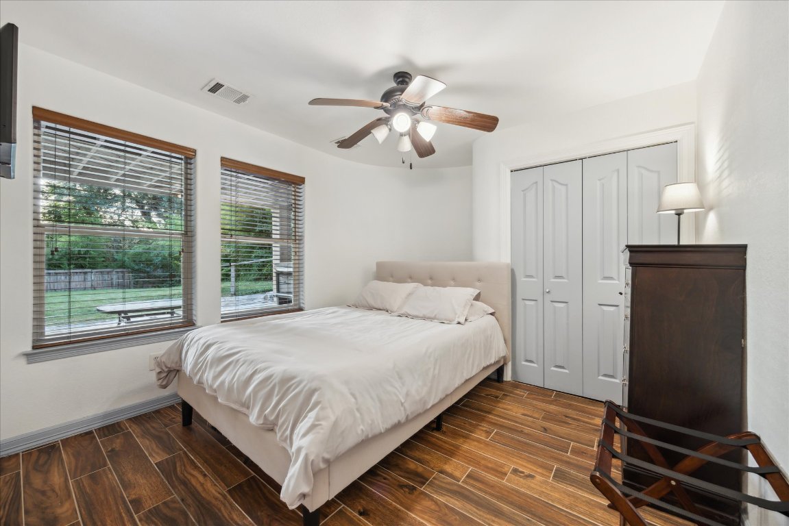 602 Jessie Street Austin, TX 78704 - Photo 24 of 32 a bedroom with a bed and wooden floor