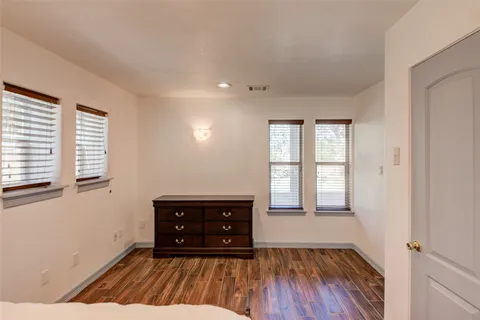 a view of wooden floor and windows in a room
