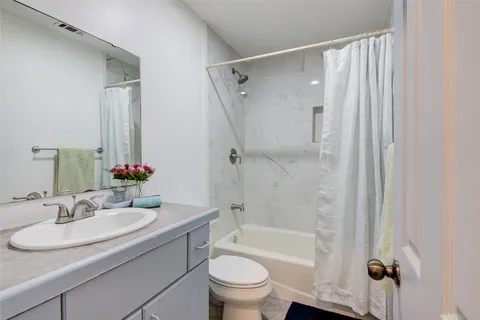 a bathroom with a sink toilet tub and shower
