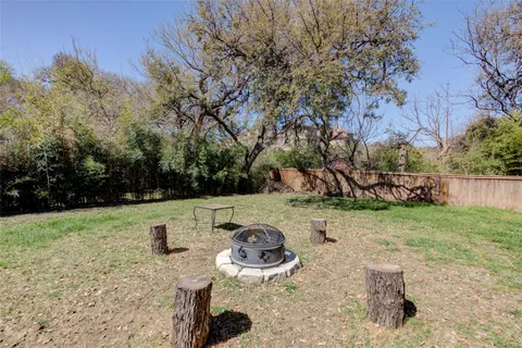 a backyard of a house with barbeque oven