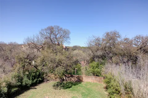 a backyard of a house with large trees