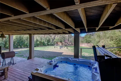 a view of a porch with furniture and a yard