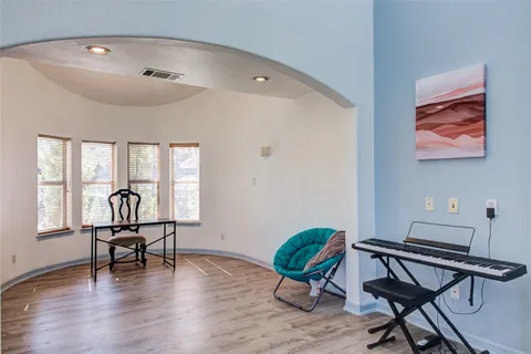 a work room with furniture and wooden floor