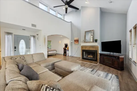 a living room with furniture a fireplace and a flat screen tv