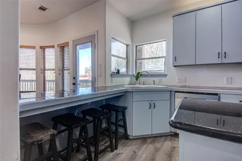 a kitchen with a sink cabinets and window