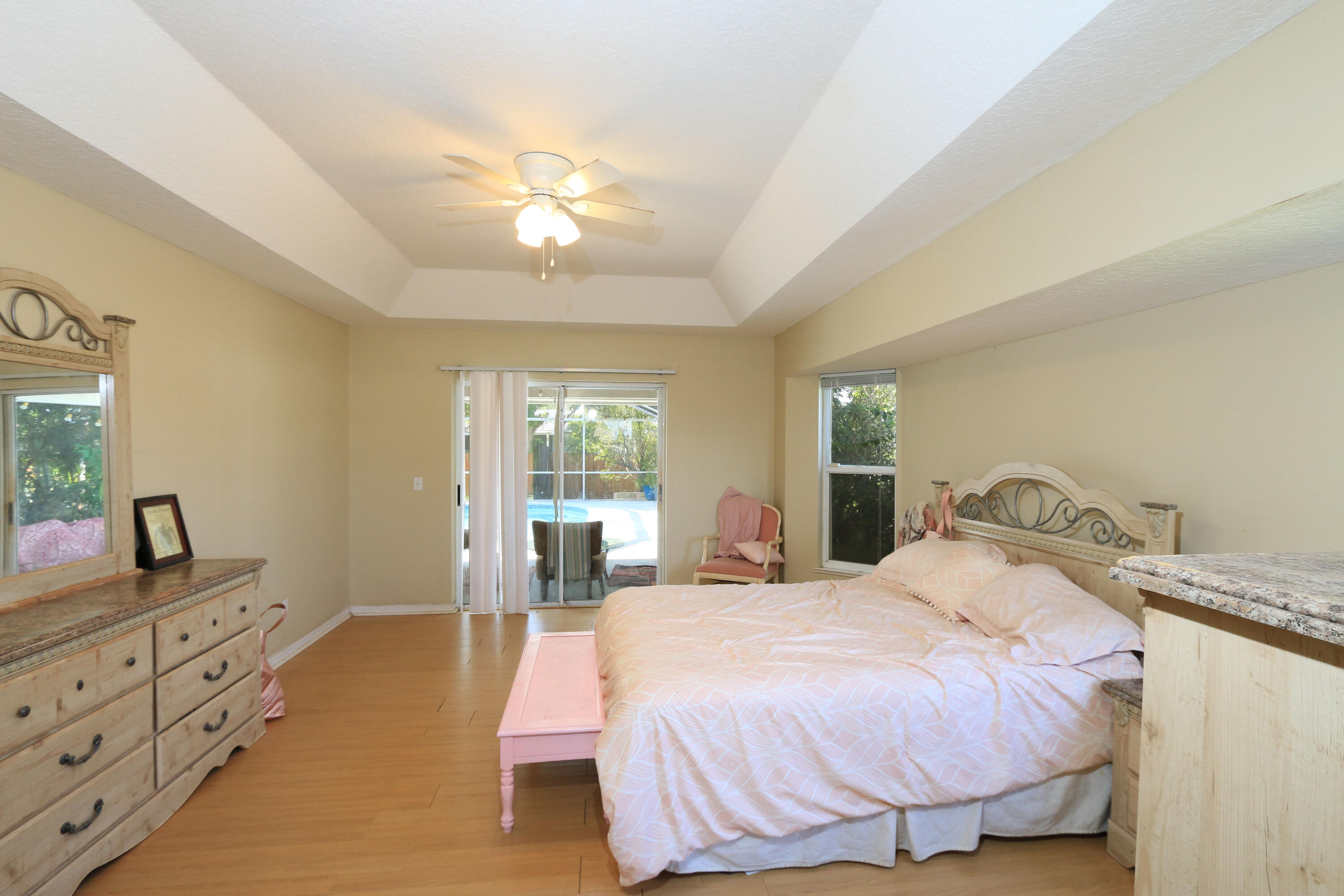 786 Southwest Bond Road Port St. Lucie, FL 34953 - Photo 16 of 33 a bedroom with a bed and a dresser
