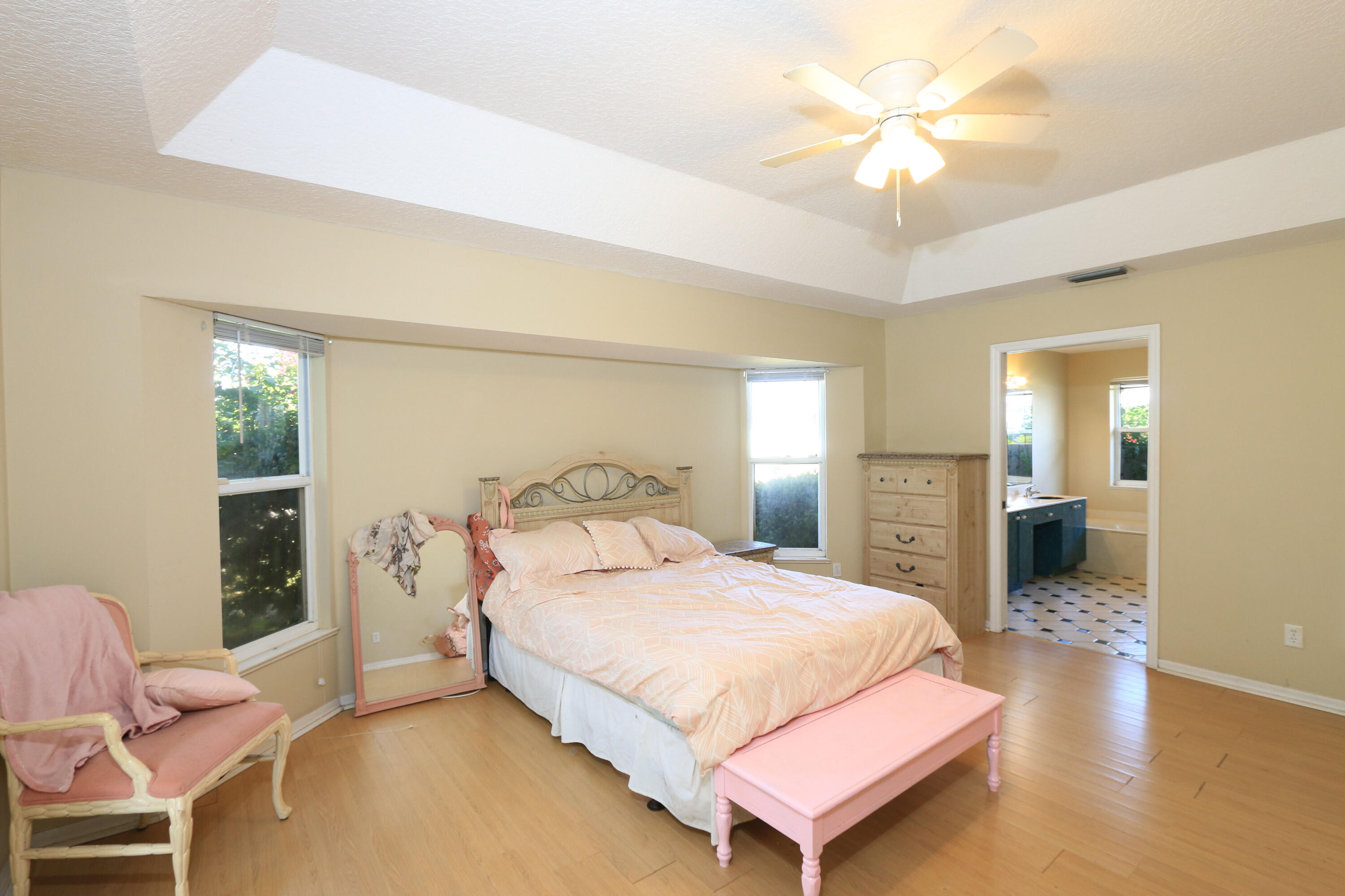 786 Southwest Bond Road Port St. Lucie, FL 34953 - Photo 17 of 33 a bedroom with a bed and a chandelier
