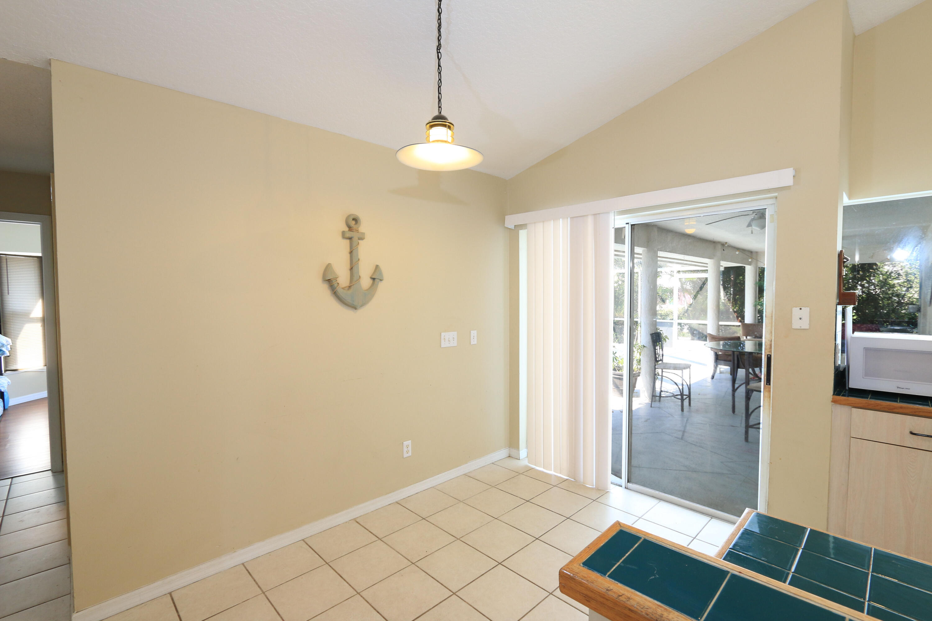 786 Southwest Bond Road Port St. Lucie, FL 34953 - Photo 20 of 33 a view of a livingroom with wooden floor and a chandelier