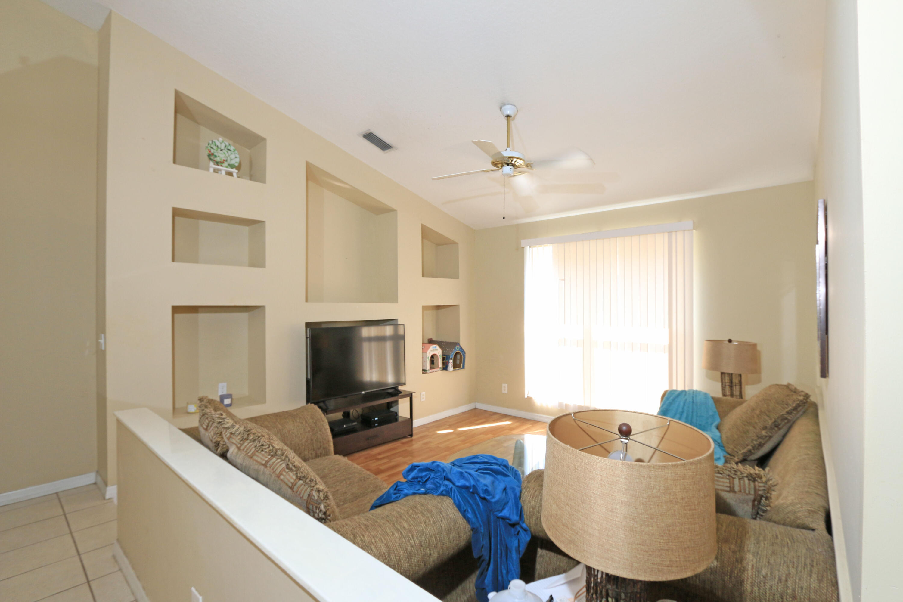 786 Southwest Bond Road Port St. Lucie, FL 34953 - Photo 21 of 33 a living room with furniture and a fireplace