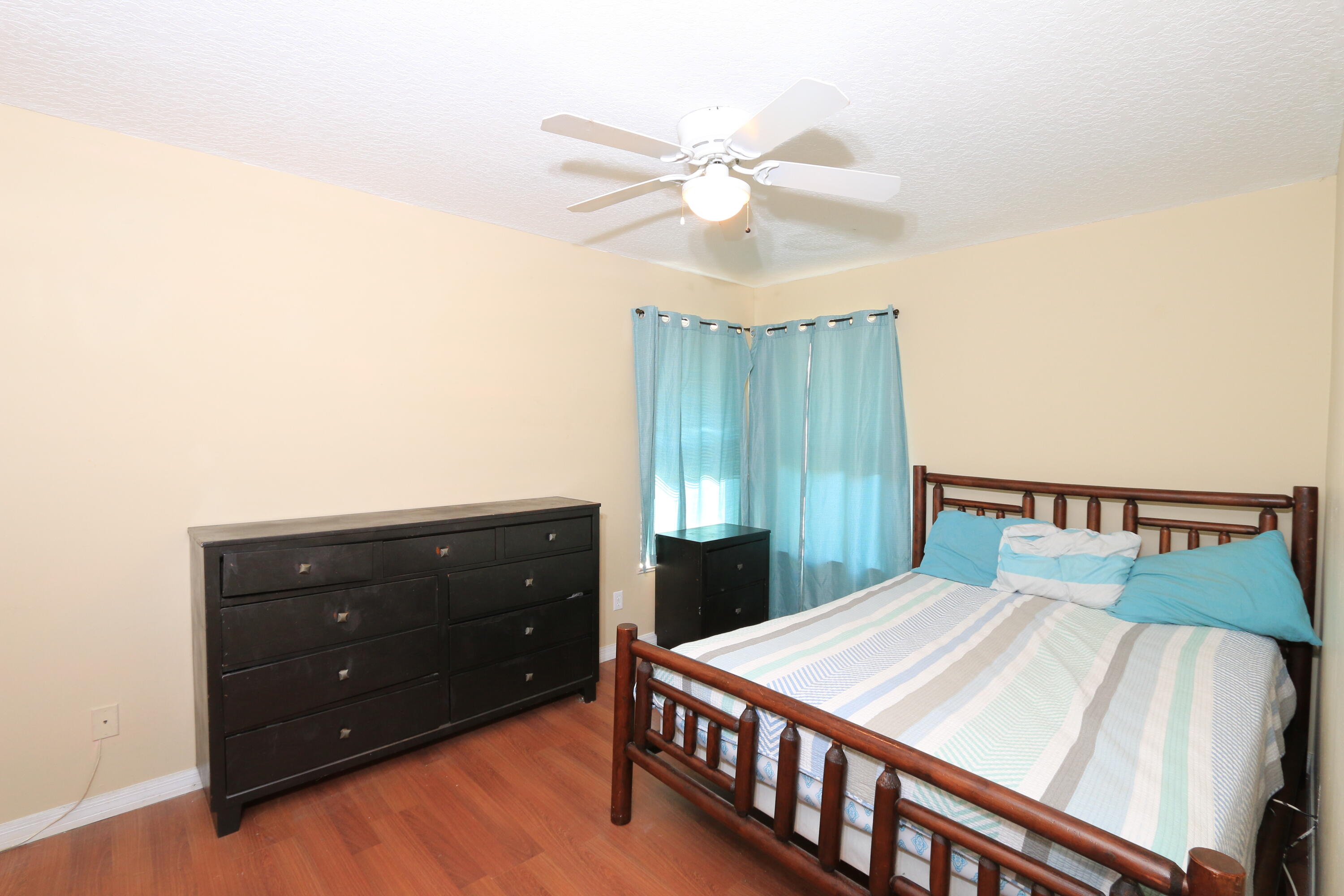 786 Southwest Bond Road Port St. Lucie, FL 34953 - Photo 23 of 33 a bedroom with a bed and a dresser