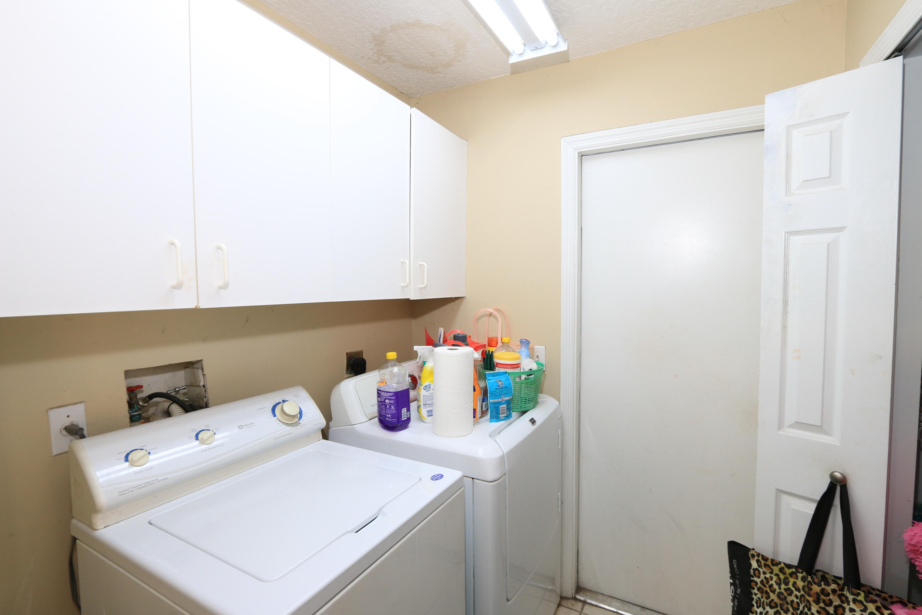 786 Southwest Bond Road Port St. Lucie, FL 34953 - Photo 29 of 33 a utility room with a refrigerator a washer and dryer