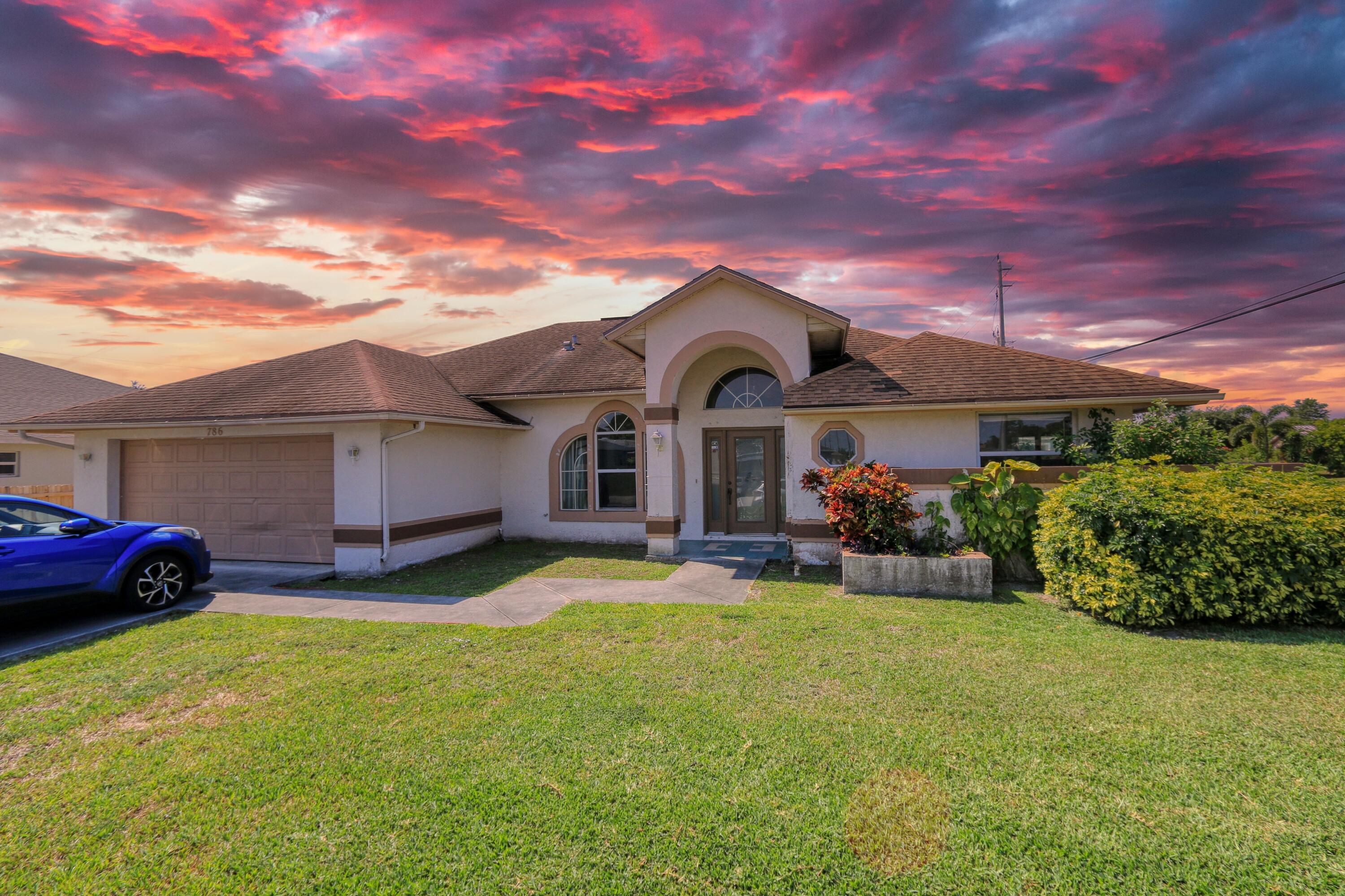 786 Southwest Bond Road Port St. Lucie, FL 34953 - Photo 30 of 33 a front view of a house with garden