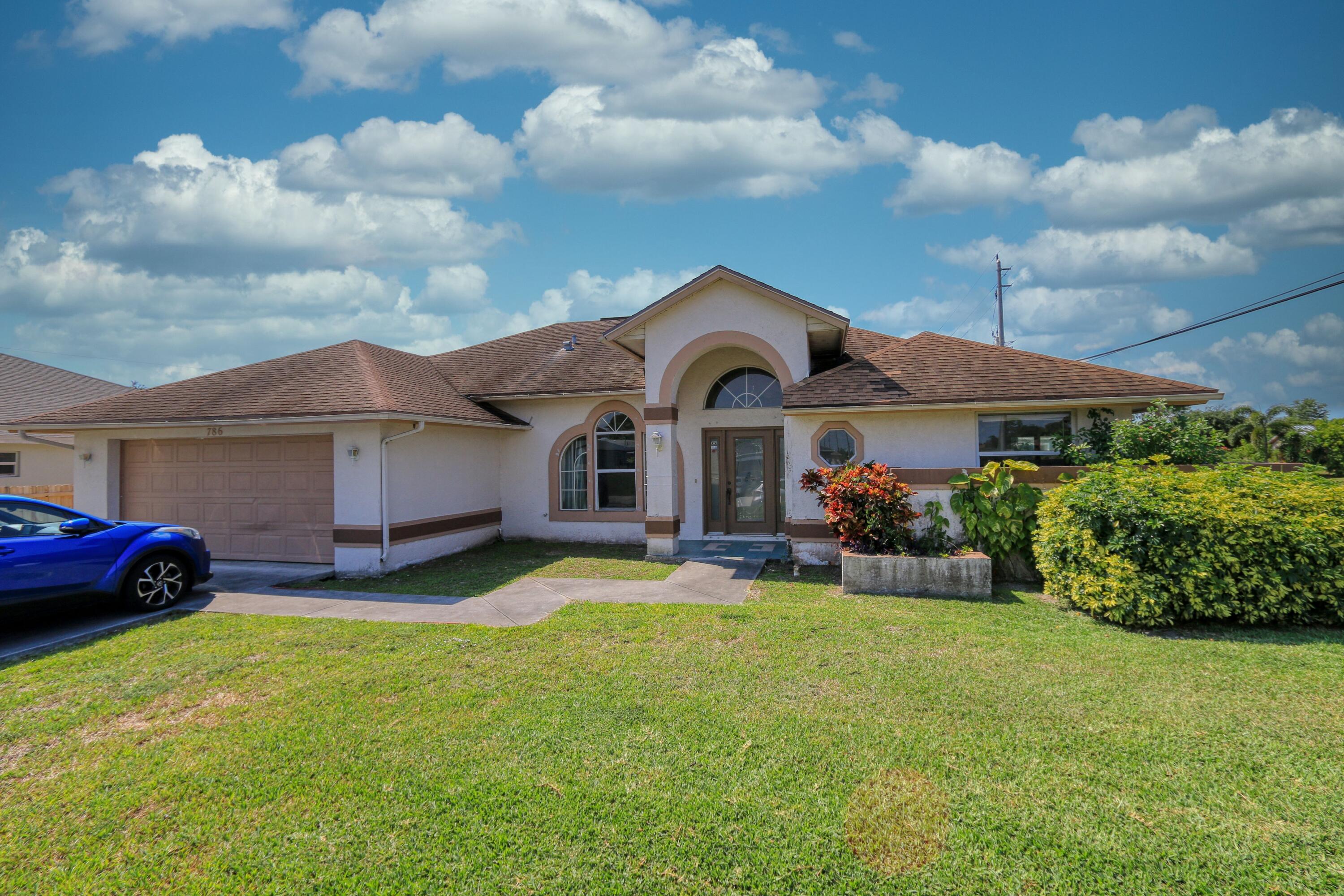 786 Southwest Bond Road Port St. Lucie, FL 34953 - Photo 31 of 33 a front view of a house with garden