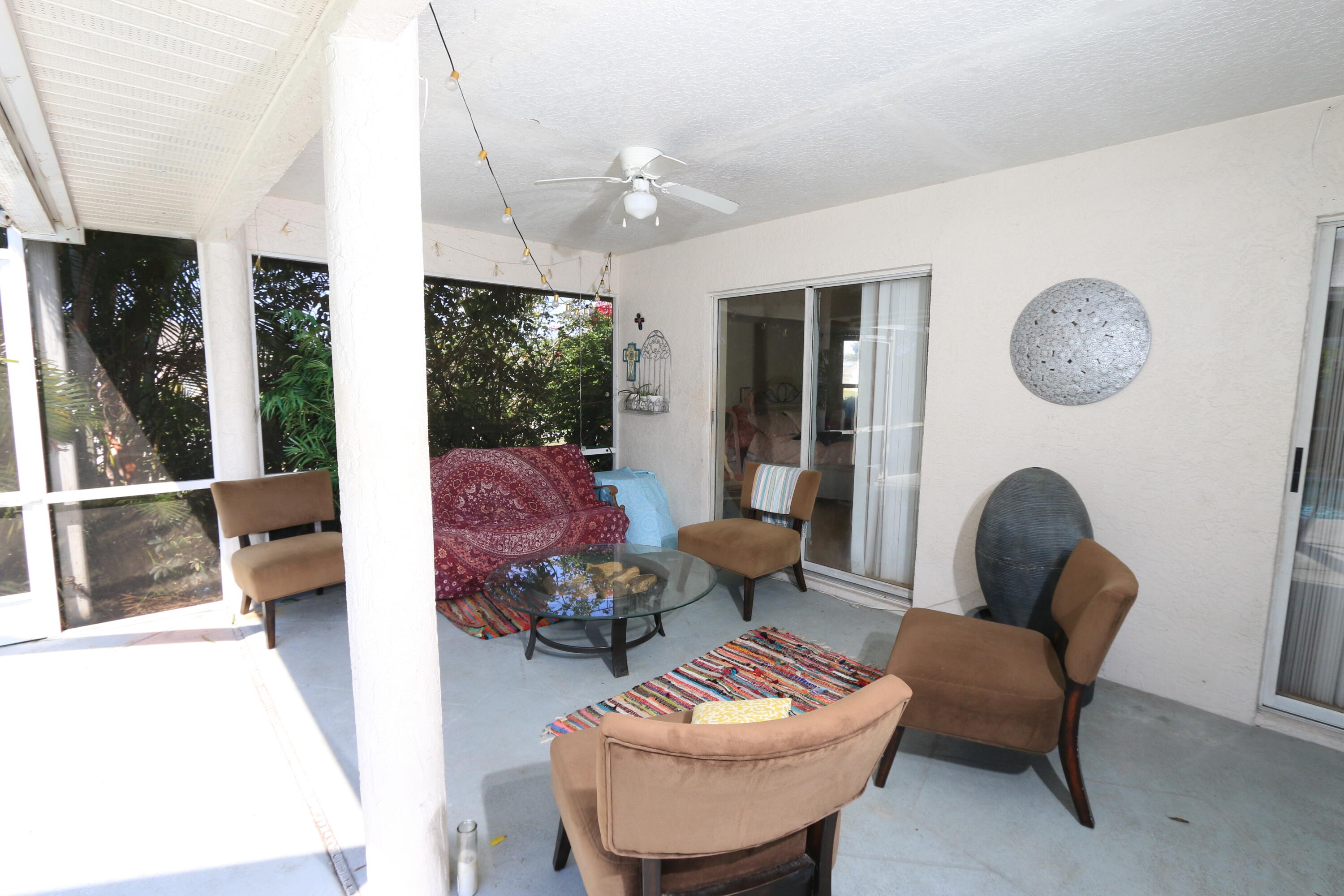 786 Southwest Bond Road Port St. Lucie, FL 34953 - Photo 4 of 33 a living room with furniture a rug and a large window