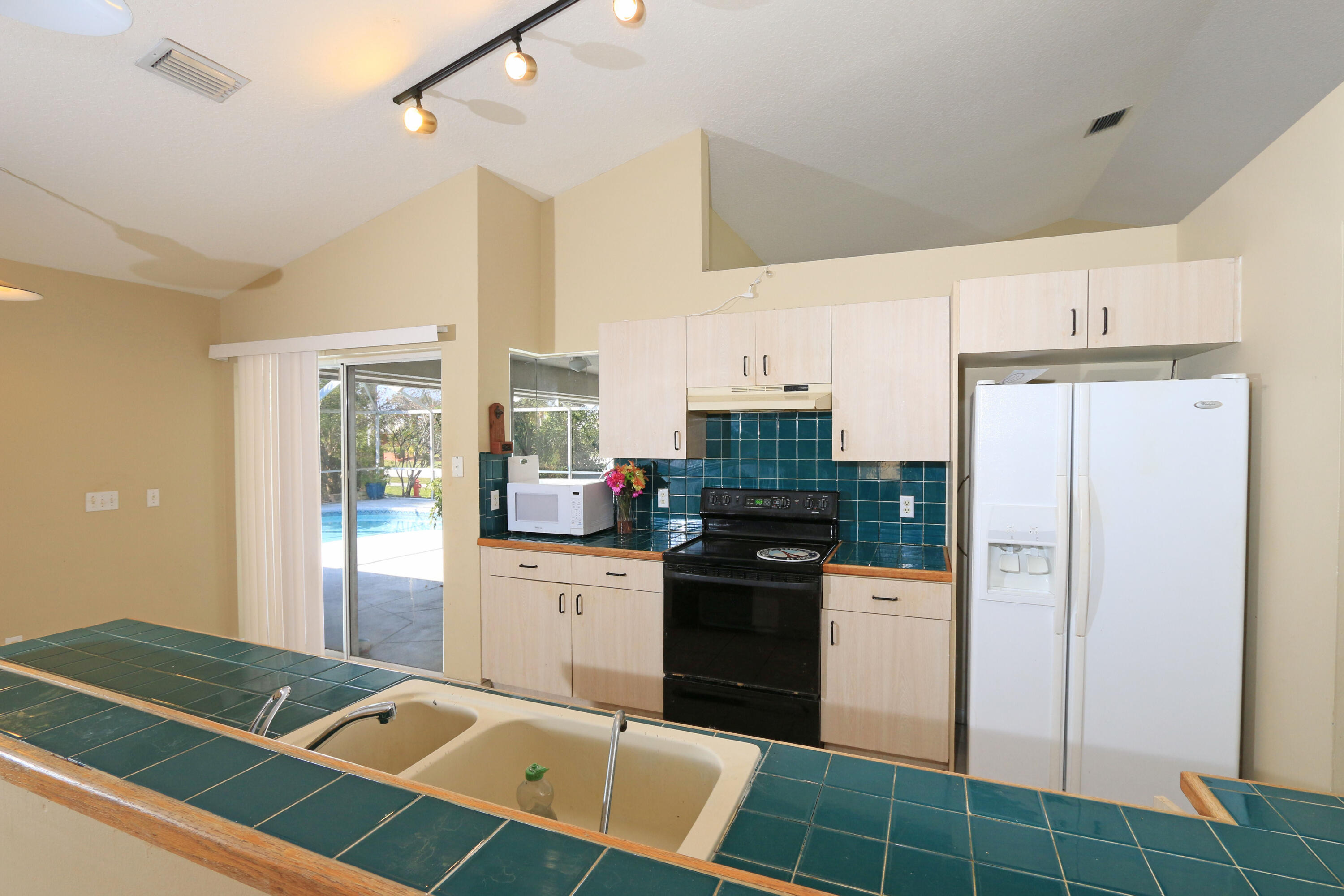 786 Southwest Bond Road Port St. Lucie, FL 34953 - Photo 5 of 33 a kitchen with stainless steel appliances granite countertop a refrigerator and a stove top oven