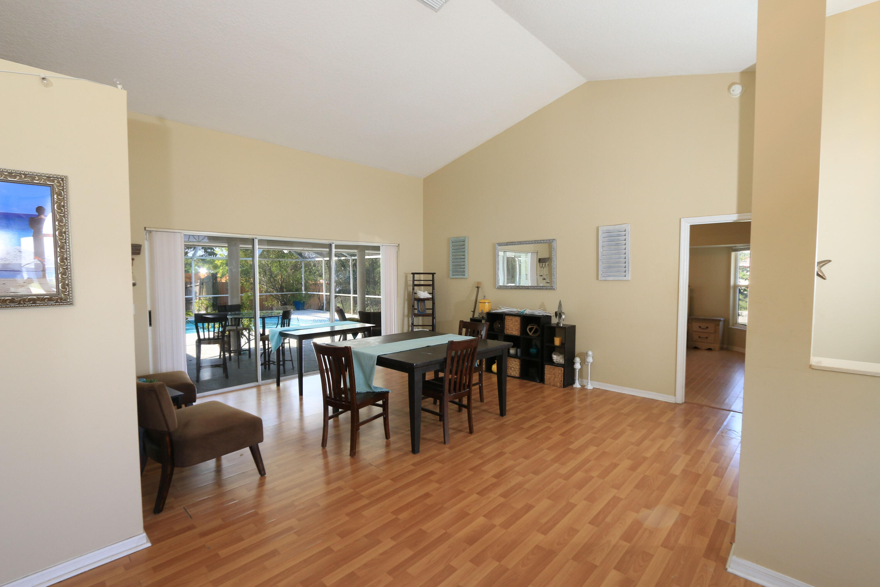786 Southwest Bond Road Port St. Lucie, FL 34953 - Photo 7 of 33 a view of a dining room with furniture and wooden floor