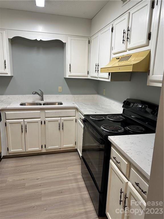 2106 South Main Street Kannapolis, NC 28081 - Photo 15 of 38 a white kitchen with granite countertop a stove and a sink