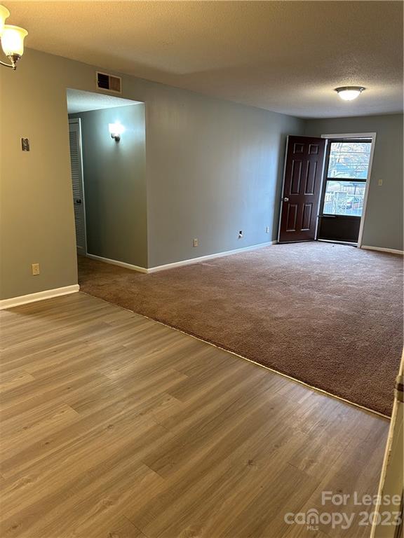 2106 South Main Street Kannapolis, NC 28081 - Photo 9 of 38 an empty room with wooden floor and windows